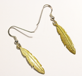 Sterling silver drop earrings with brass feathers attached from Cloud Publishing