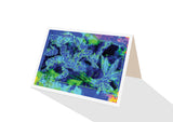 Greeting card of tropical leaves in shades of blue and a splash of colour by artist Tony Brindley and Cloud Publishing